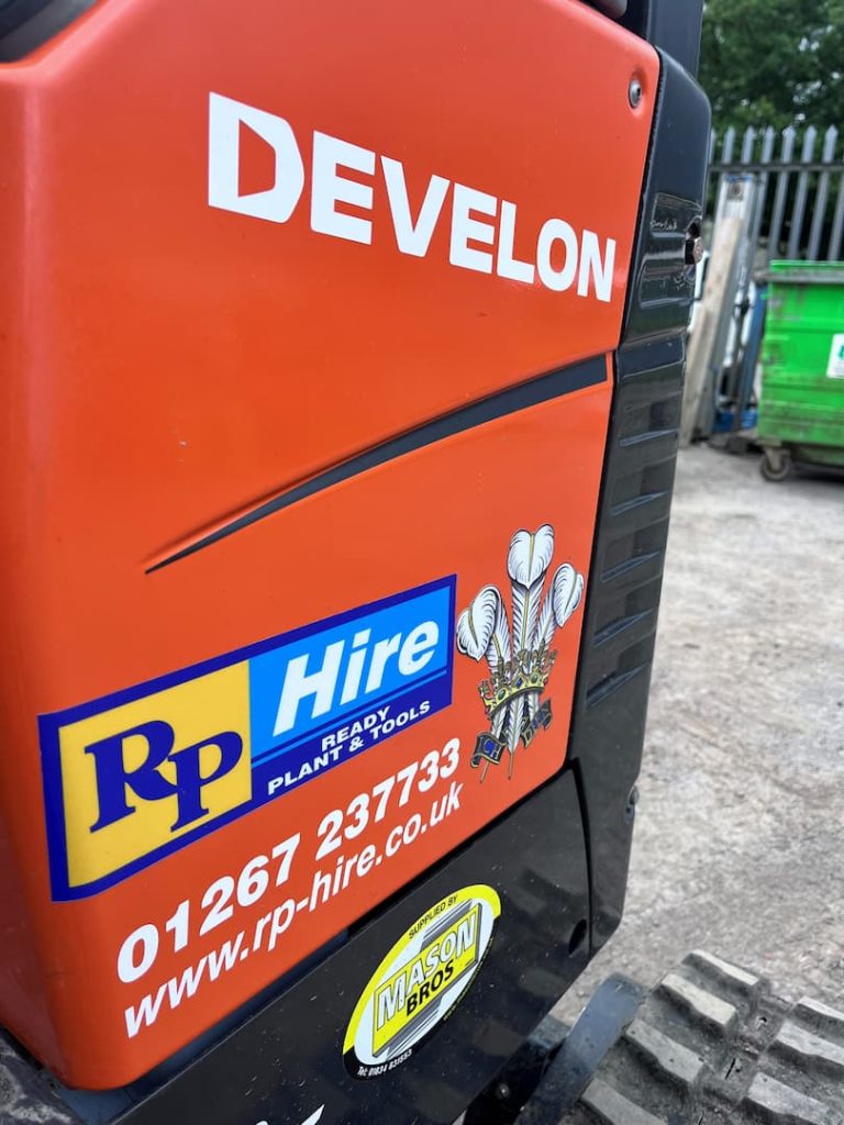 mini digger with rp hire logo on the side